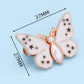 Bouton en forme de papillon qui s'adapte parfaitement