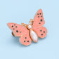 Bouton en forme de papillon qui s'adapte parfaitement