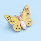 Bouton en forme de papillon qui s'adapte parfaitement